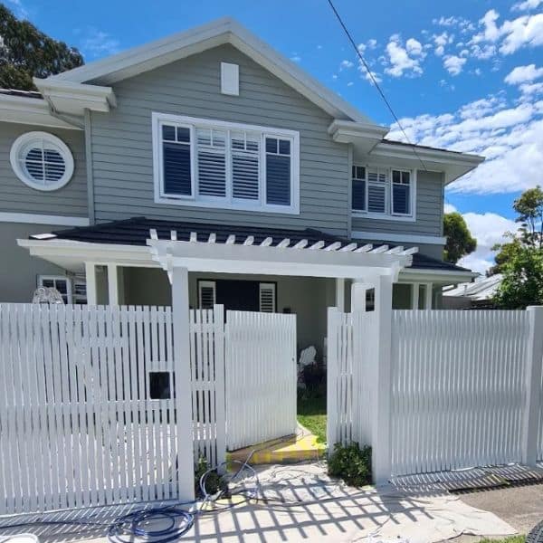 fence and airless spraying - house painted with white fence